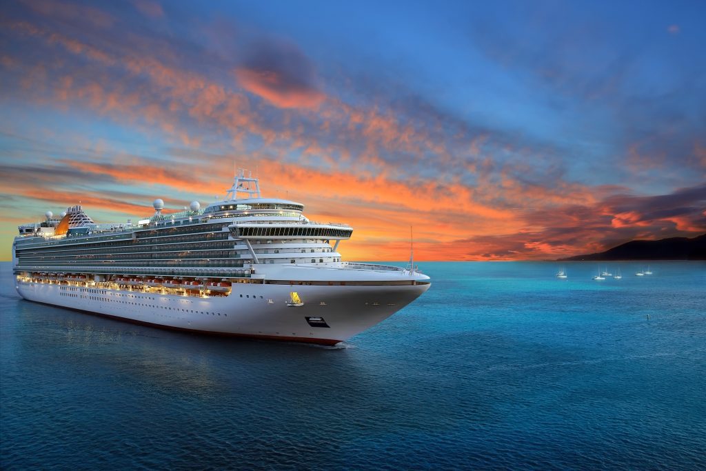 Luxury cruise ship sailing as you enjoy a beautiful sunrise.