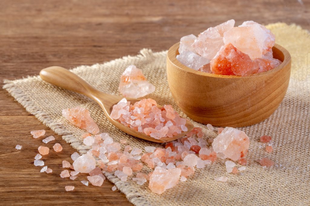 Pink salt or Himalayan Salt in a wooden bowl.