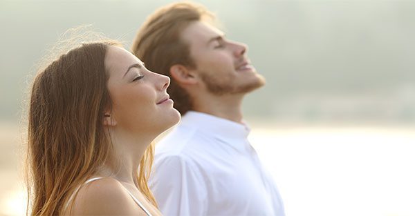 Young man and women breathing easy.