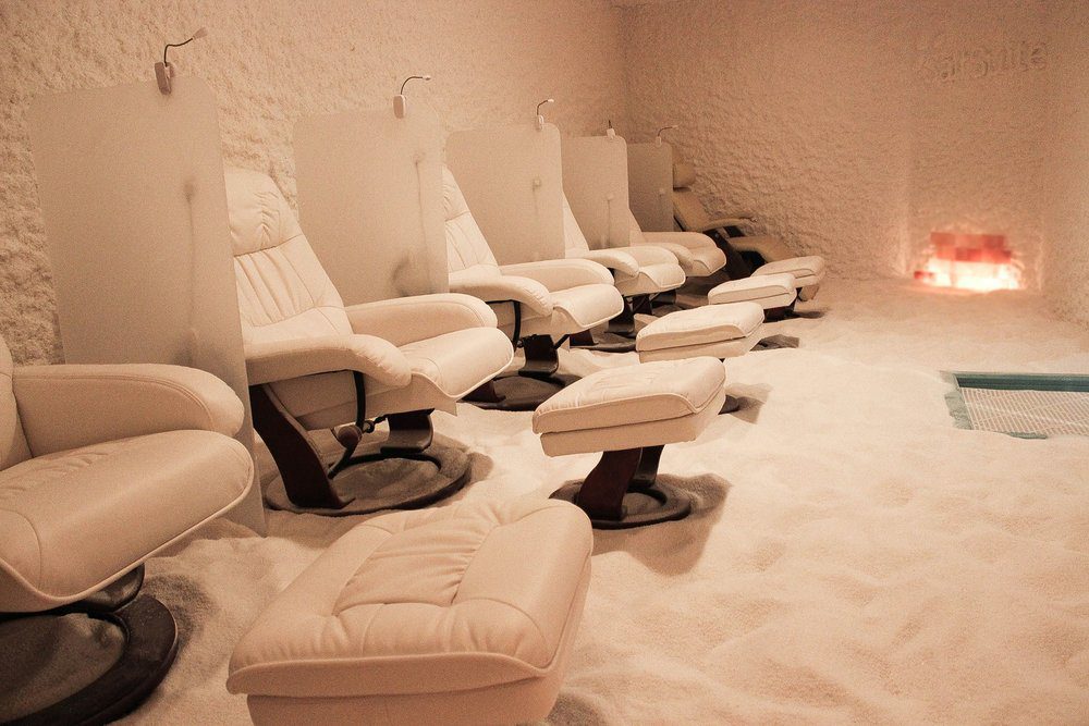 A Salt Suite with leather white chairs, salt on walls and on the floors.