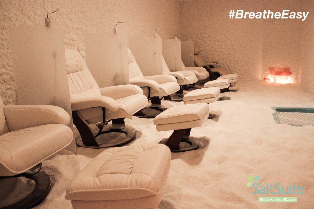 A Salt Suite with leather white chairs, salt on walls and on the floors.