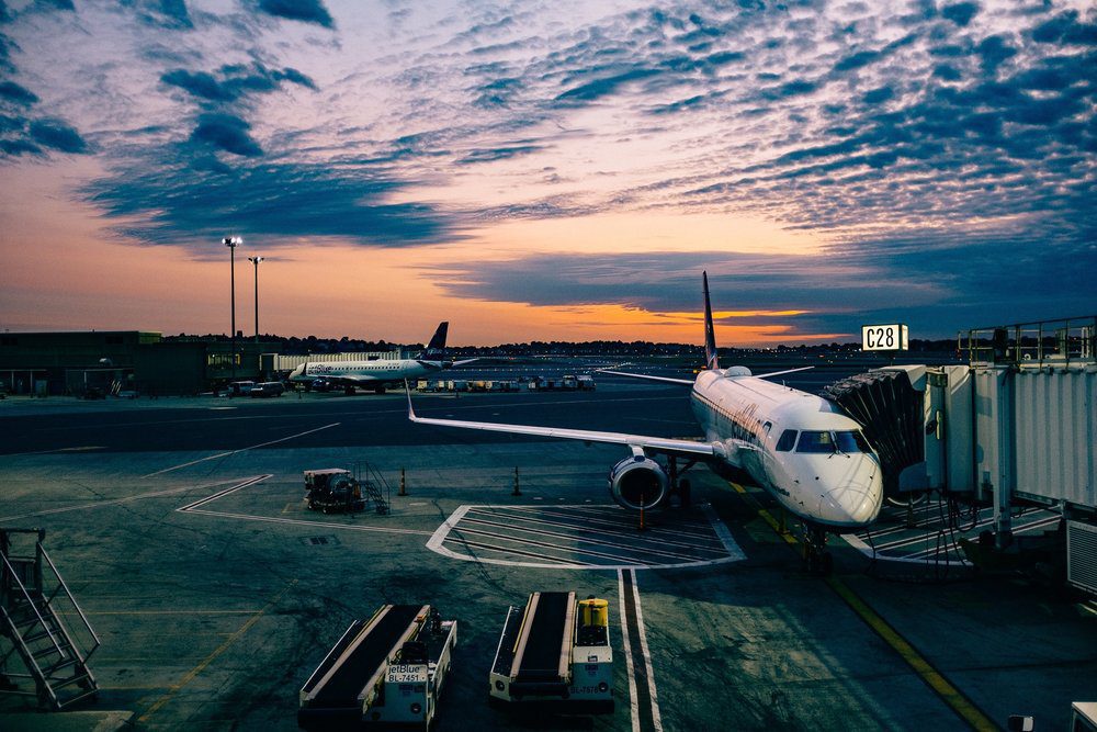 Airplane attached to passenger boarding bridge.