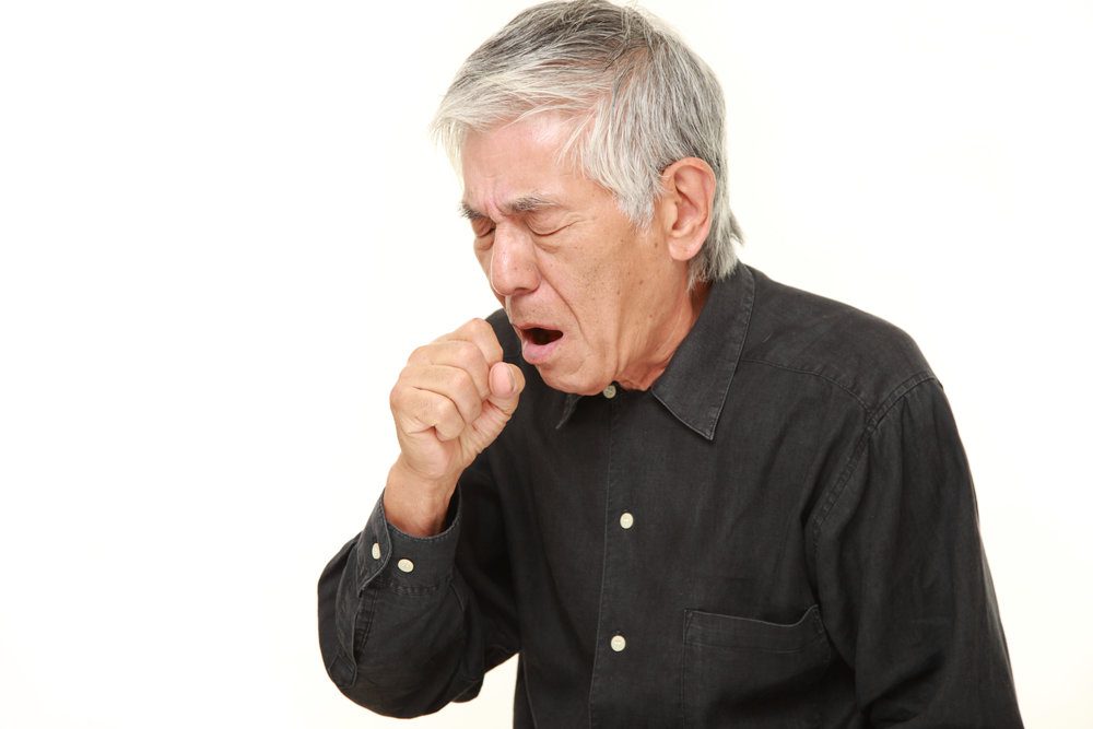 Older asian man coughing.