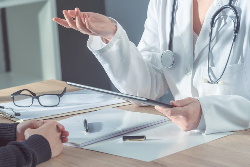 Person at a medical consultation with a doctor.