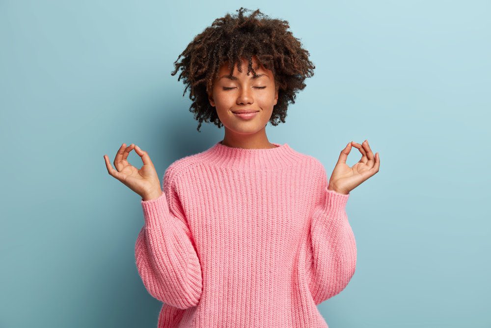 Black woman doing meditation.