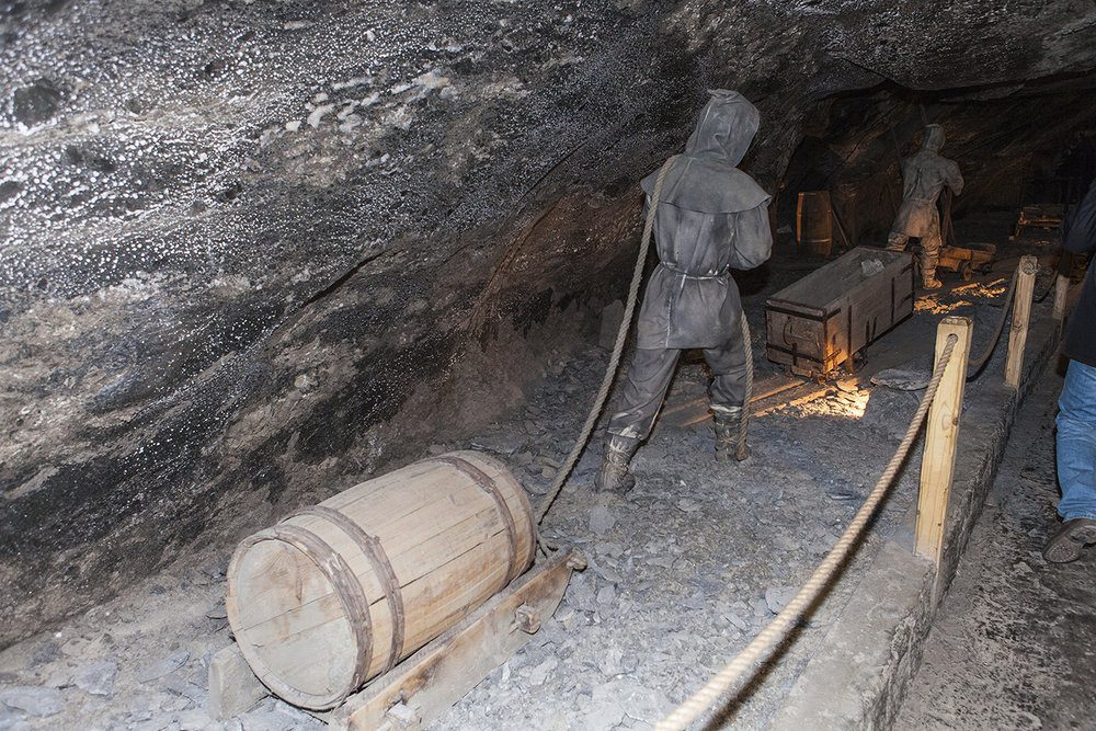 Two man hauling equipment into a salt mine.
